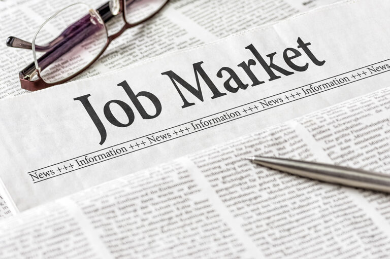 A newspaper with the headline Job Market
